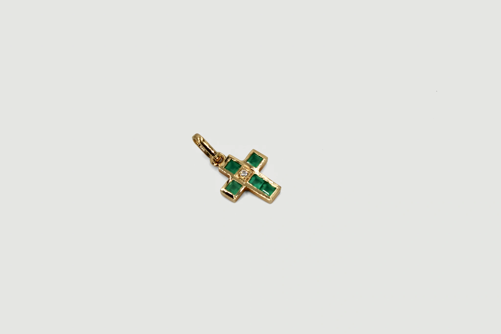Cruz de oro de 18k con piedras de color verde y circonita central